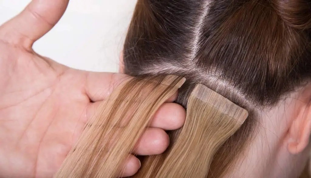 Hair Stylist Handling Tape In Extension