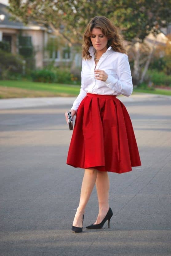lady wearing white dress shirt on red flared skirt