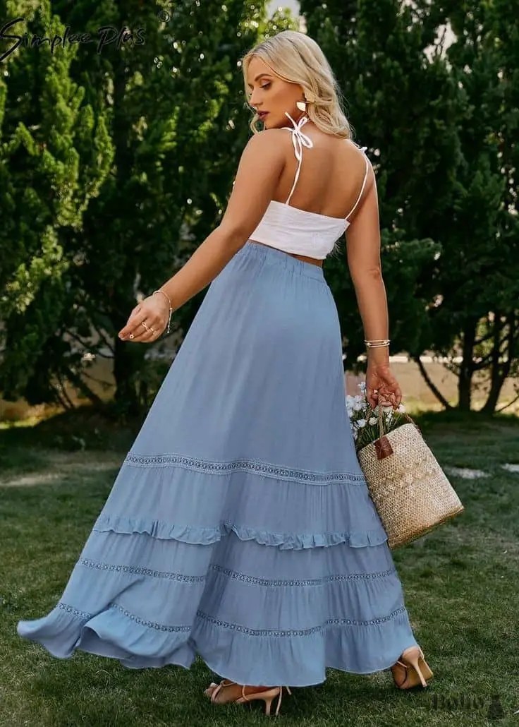 lady wearing white tank top with long flared skirt