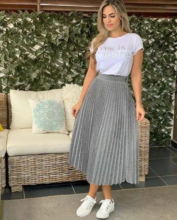 lady wearing white T-shirt with flared skirt and sneakers