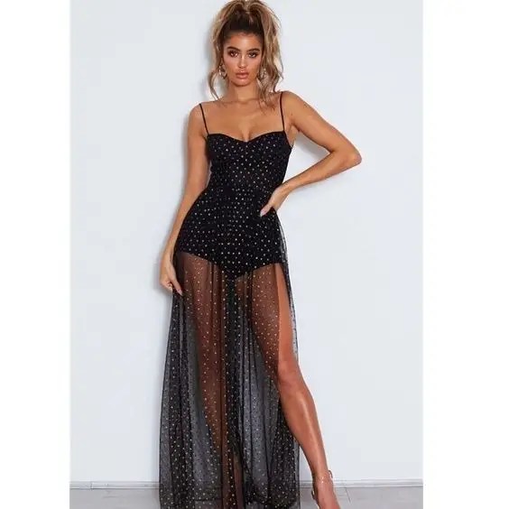 Woman wearing long sleeveless sheer dress with slit