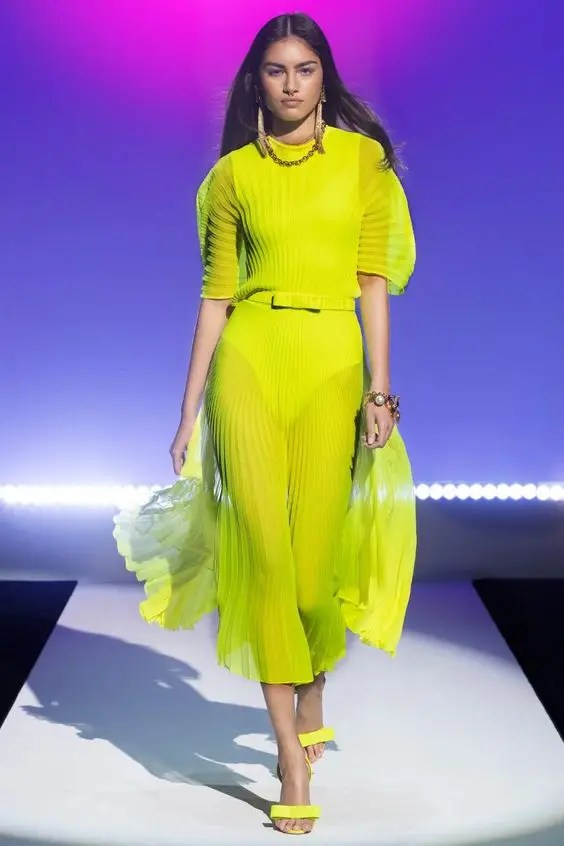 Woman wearing matching shoes and yellow sheer dress