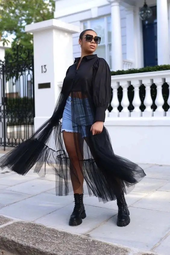 Woman wearing black sheer dress and black boots