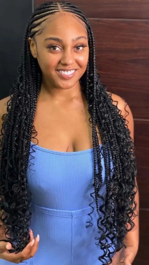 Smiling woman rocking curled Fulani braids