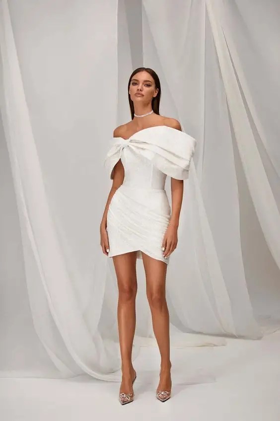 smiling woman wearing white dress with small heels