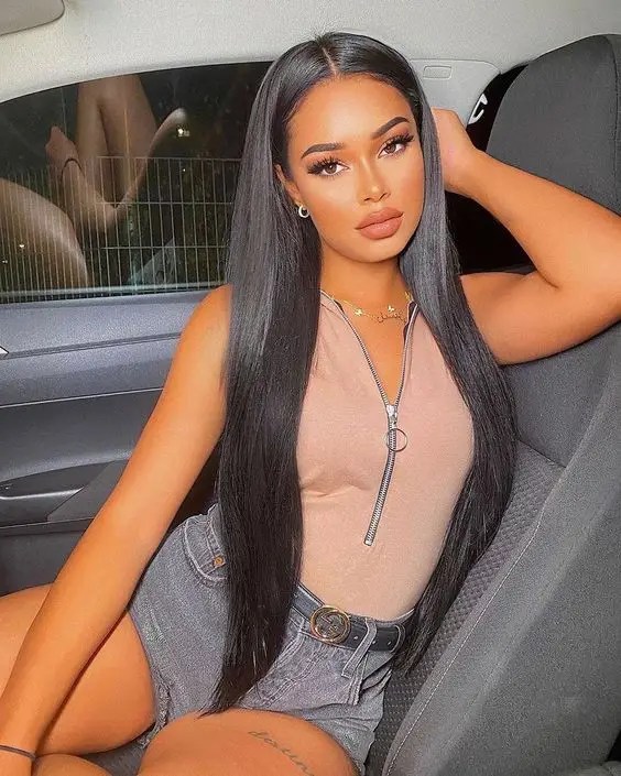 Woman rocking her long hair in the car