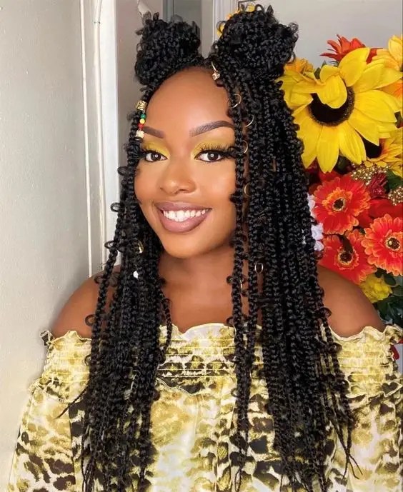 Smiling woman wear butterfly braid with two buns.