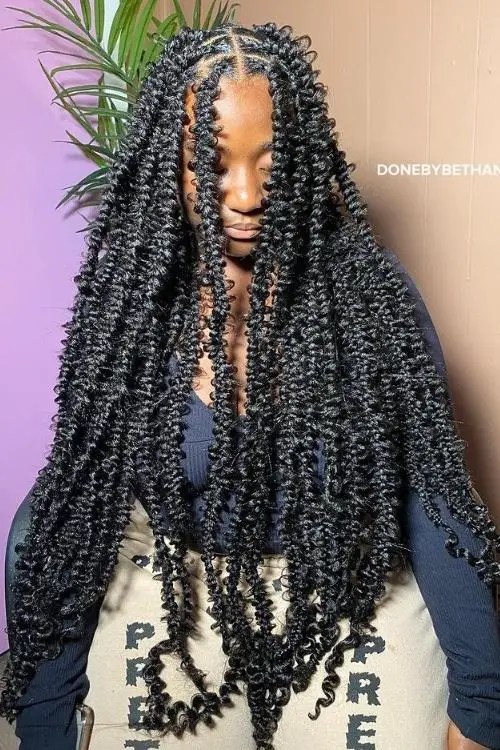 Pretty woman's face covered with butterfly braids