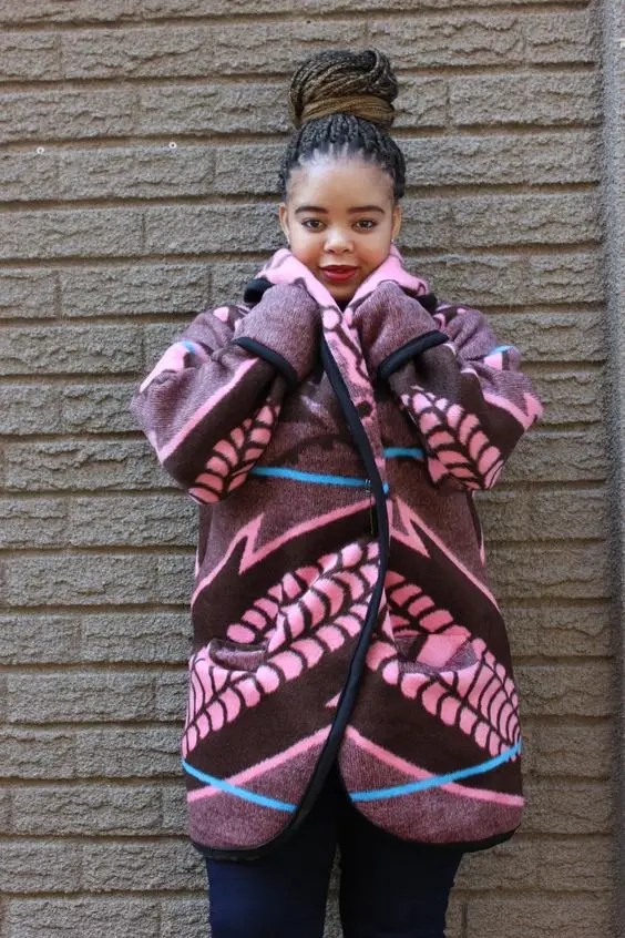 Woman wearing Sotho fabric as a cardigan