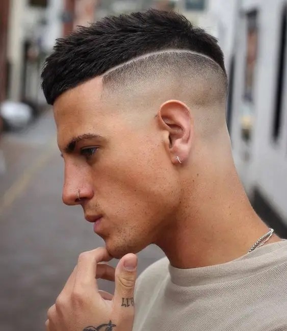 Thoughtful man wearing men's hairstyle with fade