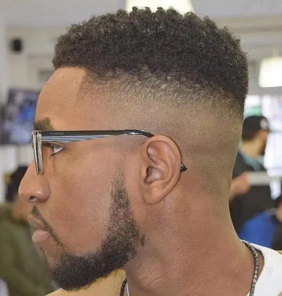 Man with glasses wearing short hairstyle with fade