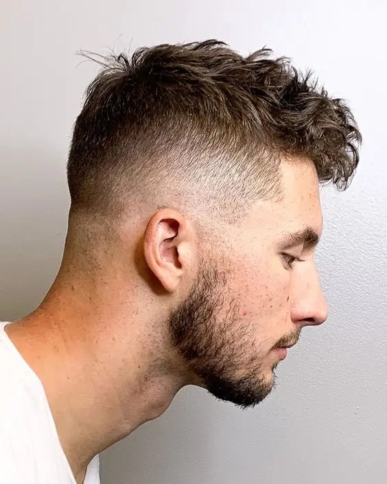 Fade wearing white with short hair