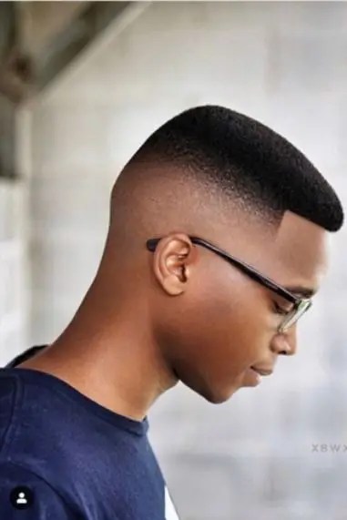 Young black man wearing short hair and a fade with glasses