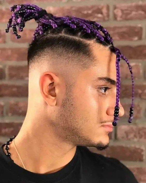 man wearing colored braids