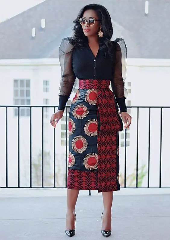 Woman in ankara pencil skirt and black shirt with puff sleeves