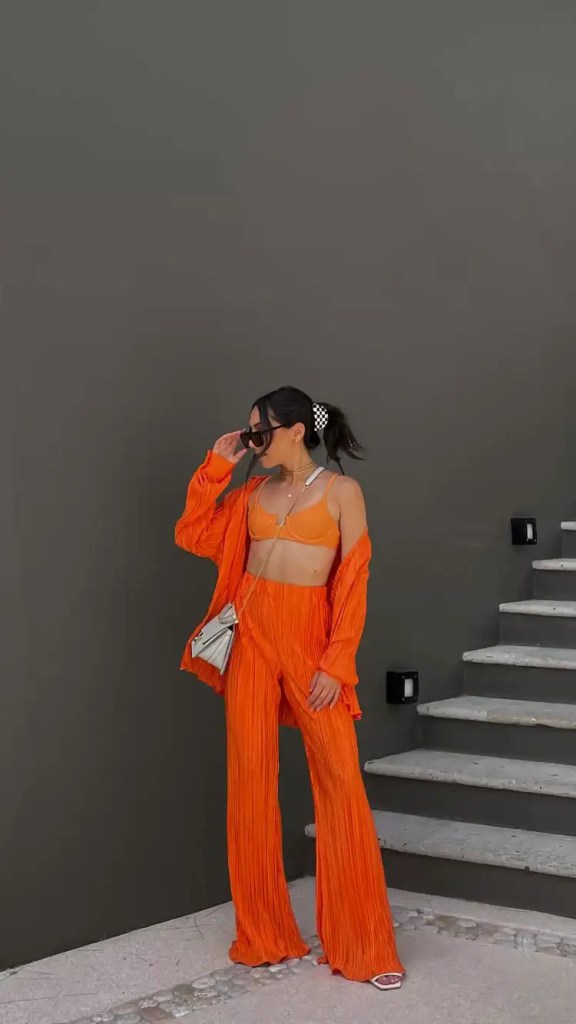 A woman wearing an orange outfit (palazzo and shirt)