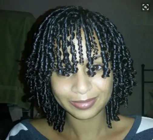 Woman twisting and styling her natural hair