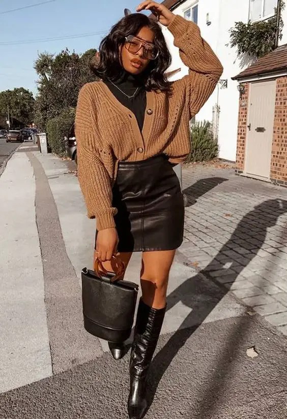 black woman in miniskirt and sweater