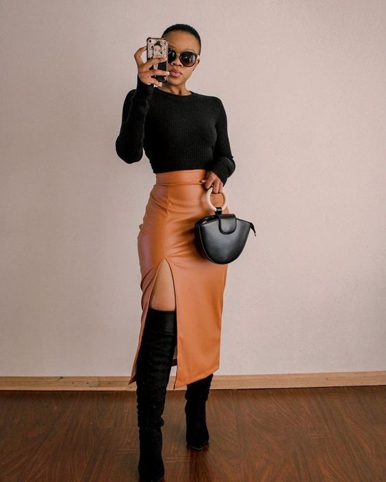 Woman wearing brown leather midi skirt and knee high boots to complement cute outfit ideas for women