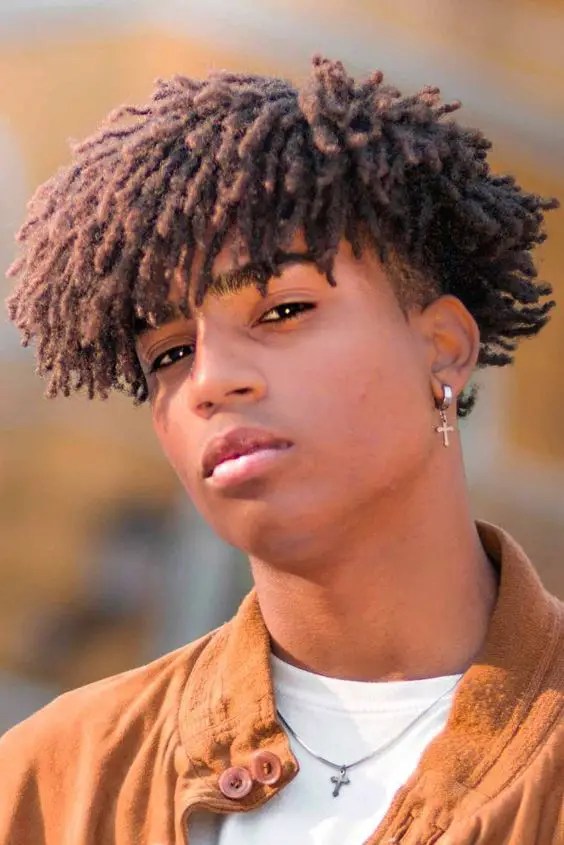 man with short brown dreadlocks