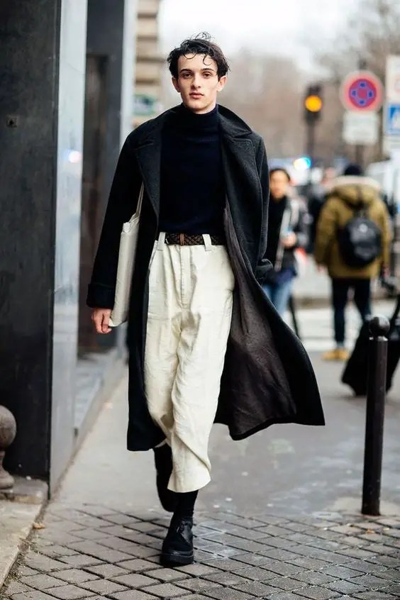 Man wearing white high-rise pants and layering with crib