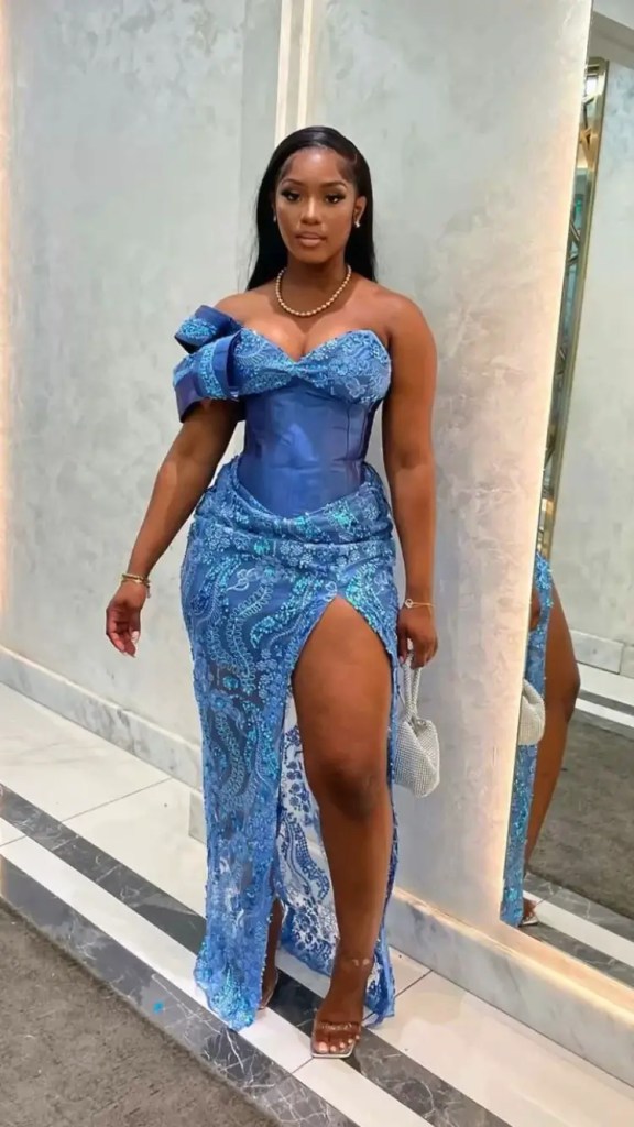 A woman wearing a corset lace asobi dress with a thigh slit