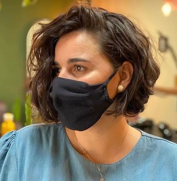 Woman wearing short layer hairstyle with face mask