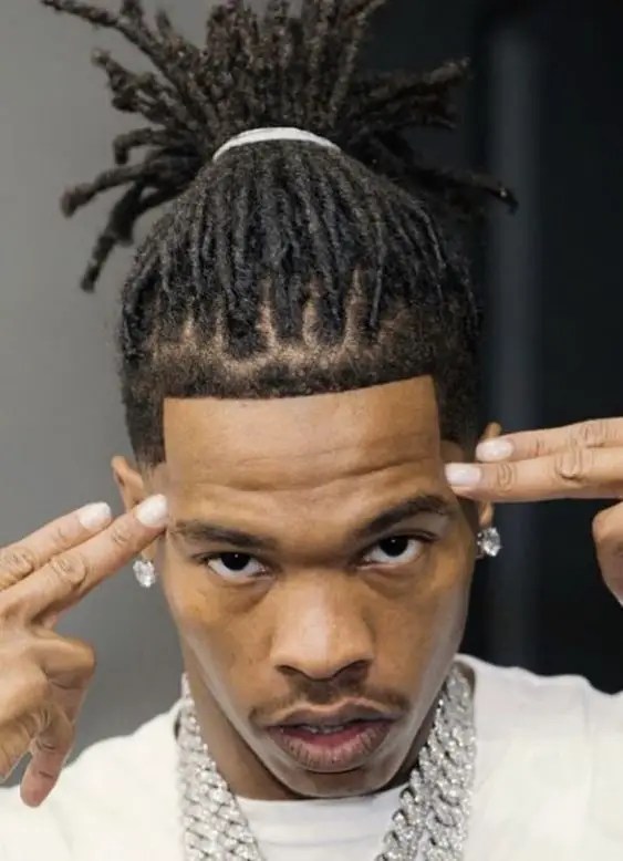 Wearing men's short dreadlocks stuffed with Lil Baby.