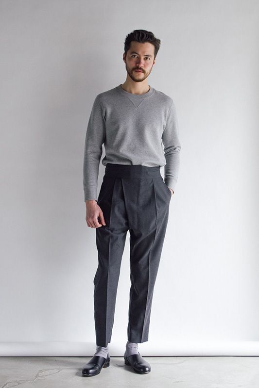 a man wearing high-waisted pants for men with ash-colored long-sleeved tee