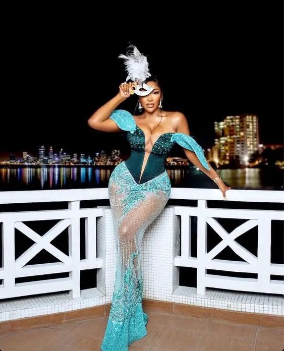 BBN Tukura wearing a blue lace gown style for a wedding during her birthday party