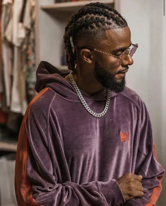 Man wearing men's braided short dread style with sunglasses
