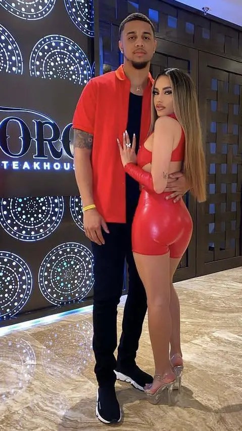 A man in a red shirt and a woman in a revealing red two-piece