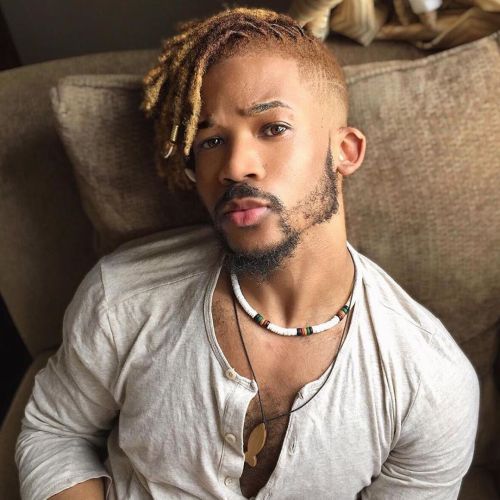 Man rocking colored dread styles for men with fades