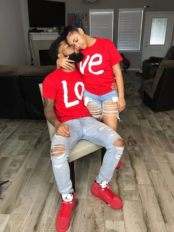 Couple wearing jeans, red t-shirt and red sneakers as Valentine's outfit for couple