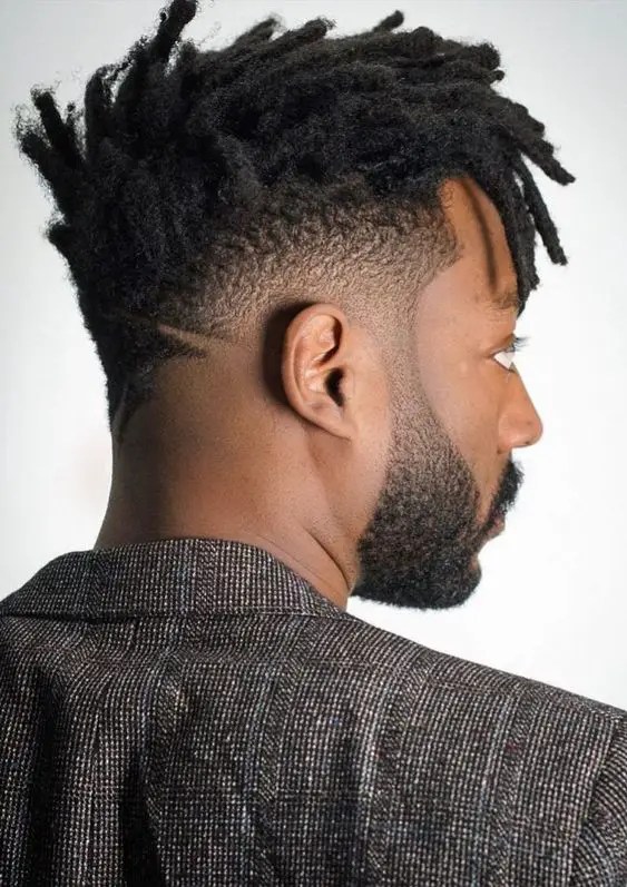 Sideways man showing men's short dreads style with fade