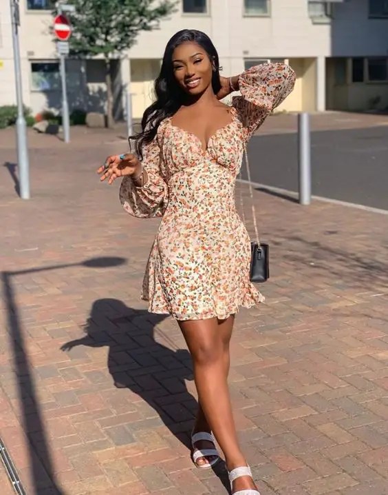 Woman in floral dress and flat slippers