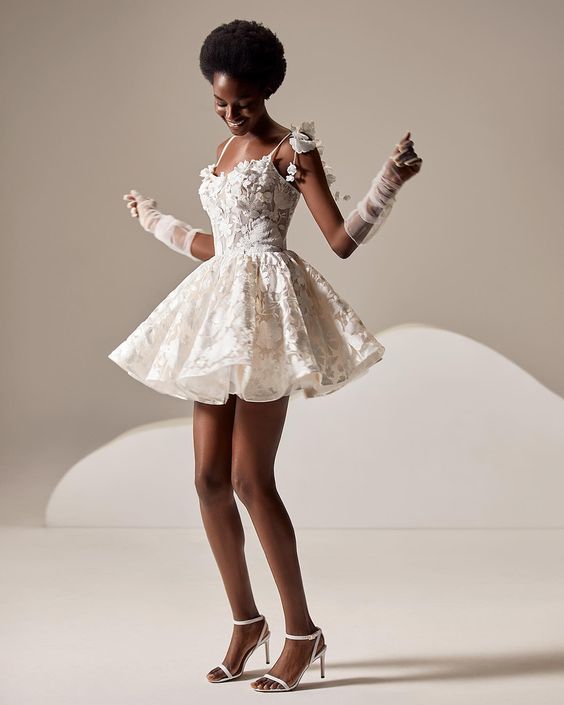 Woman wearing short white lace wedding dress