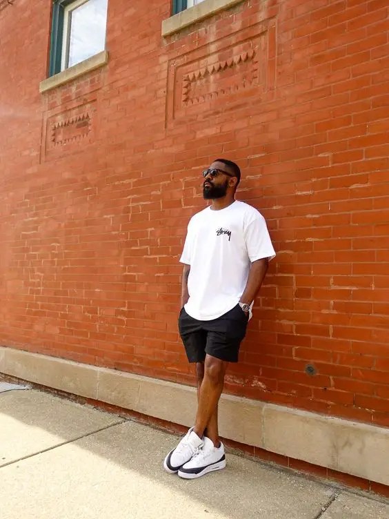 A man wearing a white t-shirt and black shorts as his election day outfit