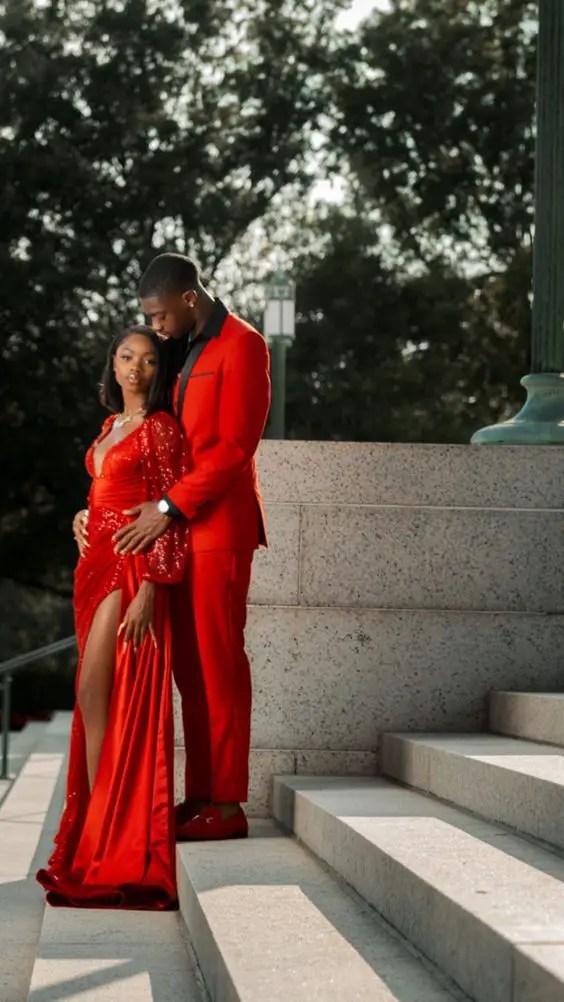 A woman in a red dinner dress and a man in a red tuxedo appear as couples' outfits for Valentine's Day