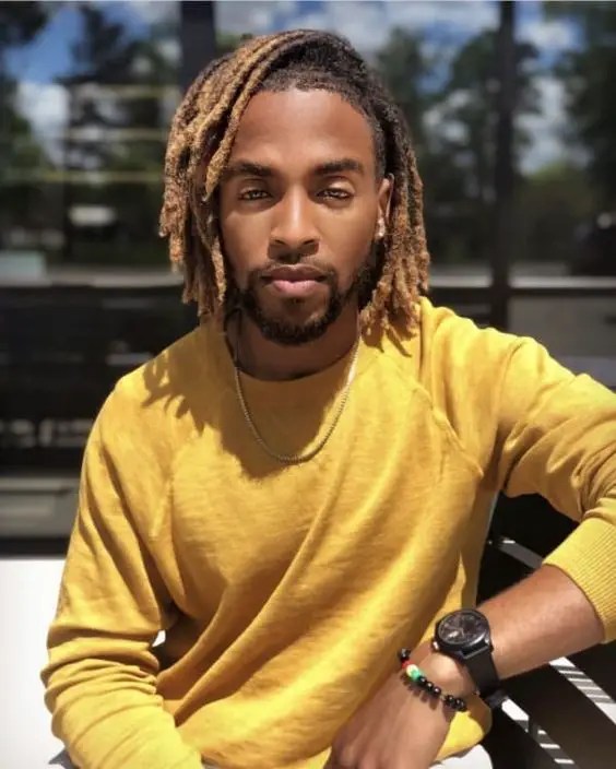 man wearing sweater and colored shirt