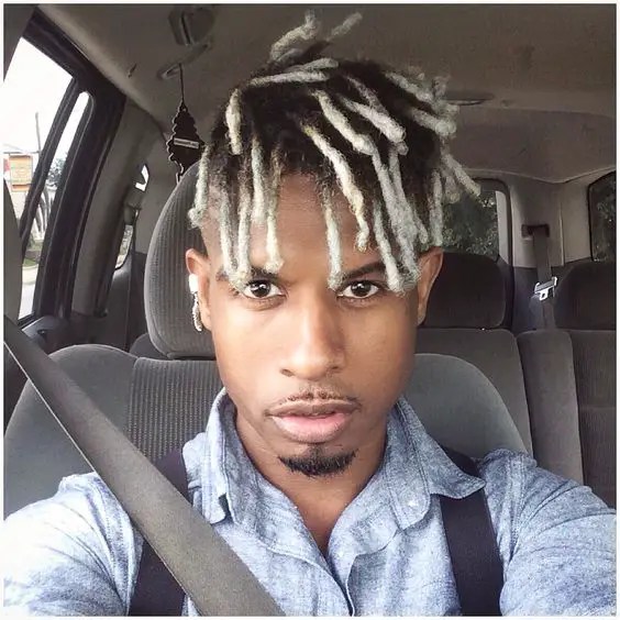 Man sitting in car showing ombre short dreadlock style for men