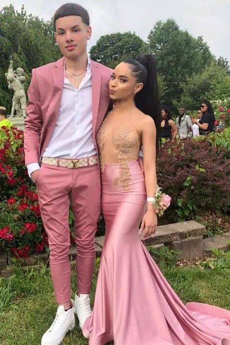 A couple wearing matching outfits (suits and dinner gowns) as Valentine's Day outfits for couples