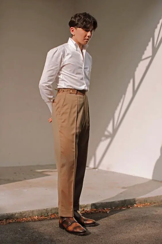 Asian man wearing high-rise pants and white shirt