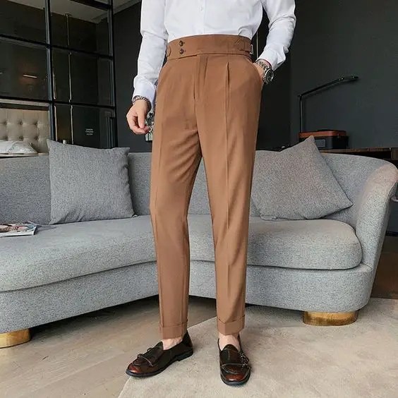 man in high waisted pants in carton brown