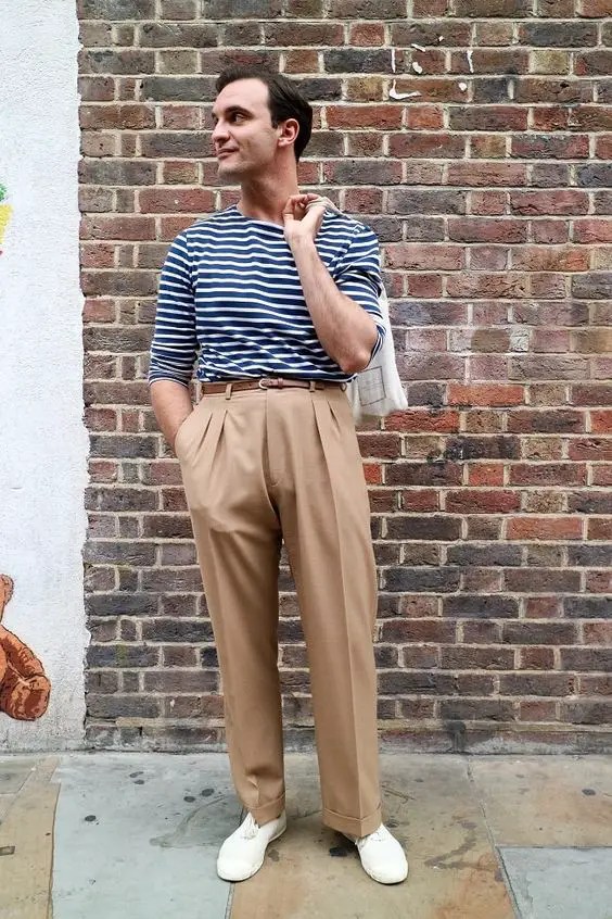 a man wearing high-waisted pants for men with a striped t-shirt
