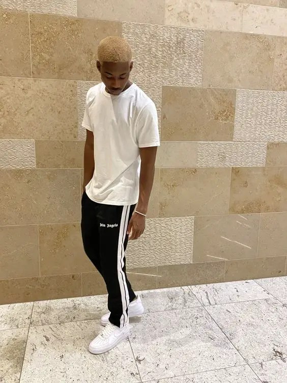 man wearing white t-shirt, black sweatpants and white sneakers