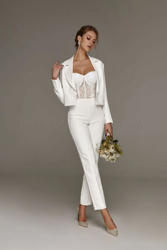 Woman wearing cropped jacket and bridal jumpsuit