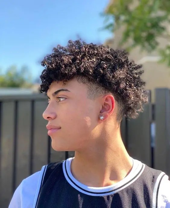 Man rocking curly hairstyle for men sideways