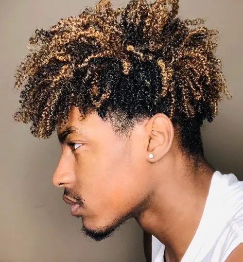 A man with curly hair on his side