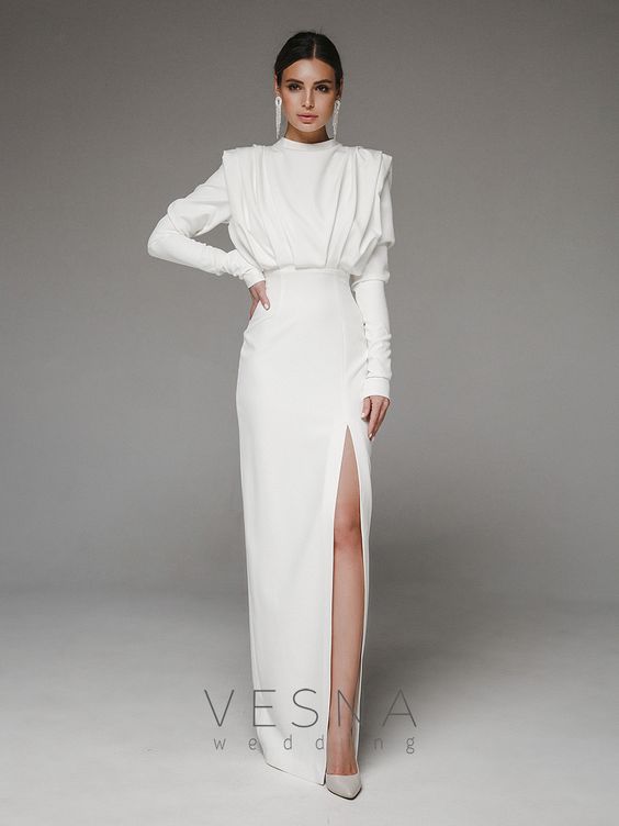 Woman in bridal white ankle length dress with side slits